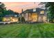 Stunning stone home with a well-manicured lawn and professionally landscaped front yard at sunset at 1801 Oatlands Ct, Wake Forest, NC 27587