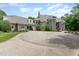 Beautiful stone home featuring a portico, three-car garage, and well-maintained landscaping at 1801 Oatlands Ct, Wake Forest, NC 27587