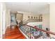 Spacious foyer with elegant staircase, wrought iron railing, hardwood floors, and beautiful architectural details at 1801 Oatlands Ct, Wake Forest, NC 27587