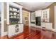 Kitchen with custom white cabinets and shelves on polished wood floor at 1801 Oatlands Ct, Wake Forest, NC 27587