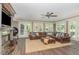 Living room with fireplace, ceiling fan, a leather sectional sofa, an area rug, and french doors to the patio at 1801 Oatlands Ct, Wake Forest, NC 27587
