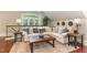 Upstairs living room area with a white sofa, hardwood floors, and a view of the staircase at 1801 Oatlands Ct, Wake Forest, NC 27587