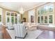 Sophisticated living room with grand windows, wood flooring, and comfortable seating at 1801 Oatlands Ct, Wake Forest, NC 27587