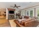 Comfortable living room with fireplace, ceiling fan, a large sectional sofa, and French doors to the patio at 1801 Oatlands Ct, Wake Forest, NC 27587