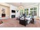 Spacious living room with a fireplace, large windows, and elegant decor at 1801 Oatlands Ct, Wake Forest, NC 27587