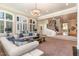 Cozy living room with large windows, plush sofa, and a wrought iron staircase at 1801 Oatlands Ct, Wake Forest, NC 27587