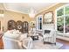 Stylish living room featuring a fireplace, mirror, comfortable seating, and natural light at 1801 Oatlands Ct, Wake Forest, NC 27587