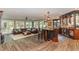 Open-concept living room features a fully stocked bar, comfortable seating, hardwood floors, and ample natural light at 1801 Oatlands Ct, Wake Forest, NC 27587