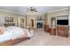 Spacious main bedroom featuring a fireplace, seating area, and views of the backyard at 1801 Oatlands Ct, Wake Forest, NC 27587