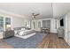 Spacious main bedroom featuring a seating area, ceiling fan, and lots of natural light at 1801 Oatlands Ct, Wake Forest, NC 27587