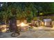 Outdoor kitchen and bar area with a built-in grill and stone accents at 1801 Oatlands Ct, Wake Forest, NC 27587