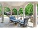 Luxury outdoor living space with seating, columns, pool, and lush greenery for ultimate relaxation at 1801 Oatlands Ct, Wake Forest, NC 27587