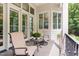 Covered porch with seating, plants, and natural light at 1801 Oatlands Ct, Wake Forest, NC 27587