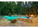 Pool and spa area with outdoor fireplace and ample seating at 1801 Oatlands Ct, Wake Forest, NC 27587