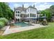 Back of home featuring an in-ground pool, spa, and lounge chairs at 1801 Oatlands Ct, Wake Forest, NC 27587