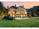 Back exterior view of home with a pool, spa and ample seating with lounge chairs at 1801 Oatlands Ct, Wake Forest, NC 27587