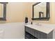 Stylish powder room features a vessel sink, decorative mirror, tile detail, and convenient open storage at 1801 Oatlands Ct, Wake Forest, NC 27587