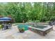 Resort-style pool featuring a spa, waterfall features, stone accents, and poolside dining area at 1801 Oatlands Ct, Wake Forest, NC 27587