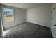 Bedroom featuring carpet, a window overlooking the lawn and a closet door for storage at 181 Tulipfield Way, Benson, NC 27504