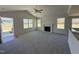 Spacious living room with a fireplace and multiple windows for natural light at 181 Tulipfield Way, Benson, NC 27504