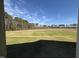The open space is large and green with a tree line in the distance against a beautiful blue sky at 181 Tulipfield Way, Benson, NC 27504