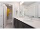 Well-lit bathroom with double sinks, sleek cabinetry, and a view into a separate toilet and shower area at 1903 Plott Balsam Dr, Wendell, NC 27591
