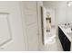Bathroom view from the hallway, showcasing vanity and an attached bedroom at 1903 Plott Balsam Dr, Wendell, NC 27591