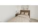 Cozy bedroom featuring neutral decor, a nightstand, and a stylish lamp at 1903 Plott Balsam Dr, Wendell, NC 27591