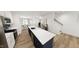 Kitchen island with bar seating, stainless steel appliances, and a view into the dining area at 1903 Plott Balsam Dr, Wendell, NC 27591
