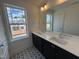Bright bathroom with double vanity, black and white tile floor, and a large window at 1903 Plott Balsam Dr, Wendell, NC 27591