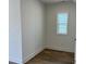 A quiet room with wood-look floors, natural light, and minimalist design at 1903 Plott Balsam Dr, Wendell, NC 27591
