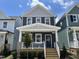 Charming two-story home features a welcoming front porch and a modern blue door at 1903 Plott Balsam Dr, Wendell, NC 27591