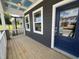 Covered front porch with wood flooring and a stylish blue front door at 1903 Plott Balsam Dr, Wendell, NC 27591