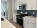 Kitchen area featuring stainless steel gas range, microwave and stylish backsplash at 1903 Plott Balsam Dr, Wendell, NC 27591