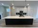Bright kitchen with white cabinets, an island with bar seating, and pendant lighting at 1903 Plott Balsam Dr, Wendell, NC 27591