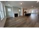 Open-concept living area with fireplace and view of kitchen with island at 1903 Plott Balsam Dr, Wendell, NC 27591