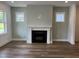 Bright living room with a modern fireplace and elegant hardwood floors at 1903 Plott Balsam Dr, Wendell, NC 27591