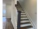 Staircase with hardwood treads and white risers, leading to the upper level at 1903 Plott Balsam Dr, Wendell, NC 27591