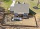 Aerial view of the home's backyard with a patio, hot tub, lush lawn, and a fenced perimeter at 193 Jenny Ln, Timberlake, NC 27583