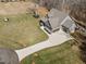 Expansive aerial view of a craftsman style house with a long driveway and well-manicured lawn at 193 Jenny Ln, Timberlake, NC 27583