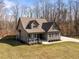 Aerial view of a charming home with a front porch, well-kept lawn, and a peaceful wooded backdrop at 193 Jenny Ln, Timberlake, NC 27583