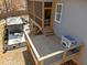 Wooden back deck with railings offers a view of the landscaped yard and outdoor seating area with hot tub at 193 Jenny Ln, Timberlake, NC 27583