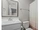 Bathroom featuring a single sink, toilet, and shower with neutral colors, ideal for relaxation at 193 Jenny Ln, Timberlake, NC 27583