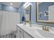 A bathroom with double sinks, patterned tile floor, and white shower curtain for a clean look at 193 Jenny Ln, Timberlake, NC 27583