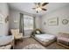 A cozy bedroom with a twin bed, rocker and soft carpet, creating a serene space at 193 Jenny Ln, Timberlake, NC 27583