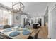 Dining room and kitchen with an elegant light fixture and open layout with a large black kitchen island at 193 Jenny Ln, Timberlake, NC 27583
