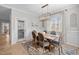 Bright dining room with a wooden table, six chairs, and stylish chandelier under natural light at 193 Jenny Ln, Timberlake, NC 27583