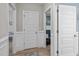 Hallway with neutral paint, raised wall paneling, hardwood floors, and multiple doorways at 193 Jenny Ln, Timberlake, NC 27583
