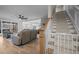 An open-concept living room connects to a modern kitchen and features wood floors and a staircase at 193 Jenny Ln, Timberlake, NC 27583