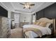 Spacious bedroom featuring a tray ceiling, ceiling fan, and large bed with neutral tones and natural light at 193 Jenny Ln, Timberlake, NC 27583
